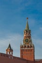 Famous Spasskaya Clock Tower and the TsarÃ¢â¬â¢s Tower of the ancient Moscow Kremlin against a blue sky